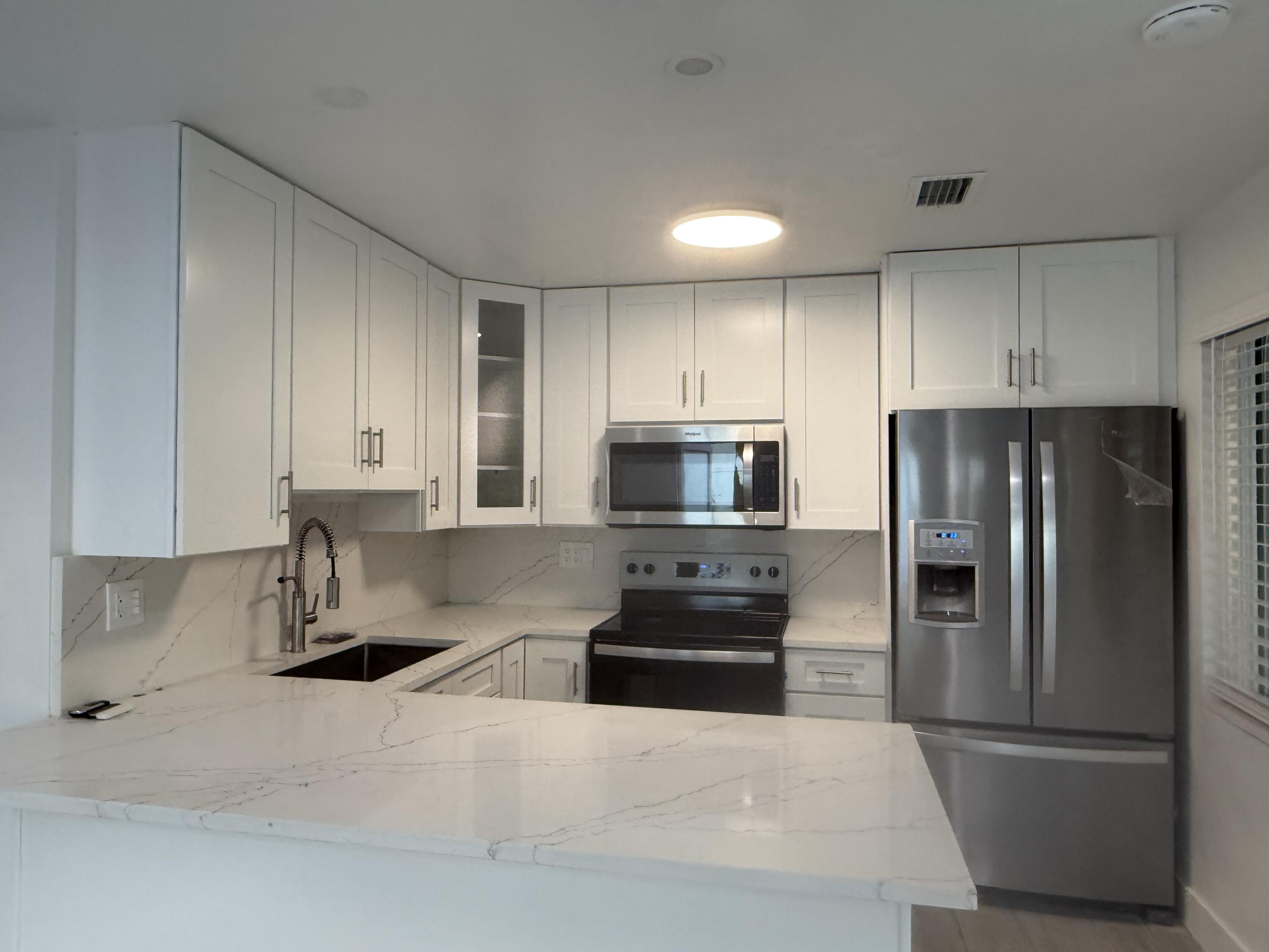 29656 Constitution Avenue Big Pine Key, FL 33043 - Photo 9 of 15 a kitchen with stainless steel appliances granite countertop a refrigerator sink and stove