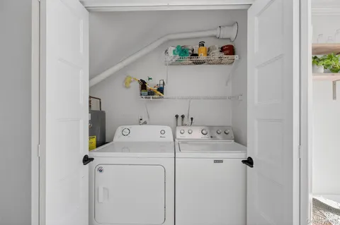 a kitchen with granite countertop a stove top oven a sink dishwasher a dining table and chairs with wooden floor