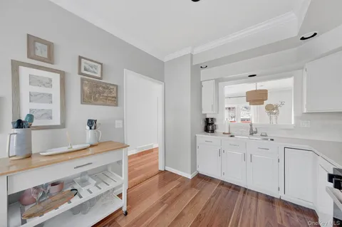 a view of kitchen with furniture wooden floor and window
