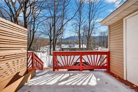 a view of a patio with table and chairs and wooden fence