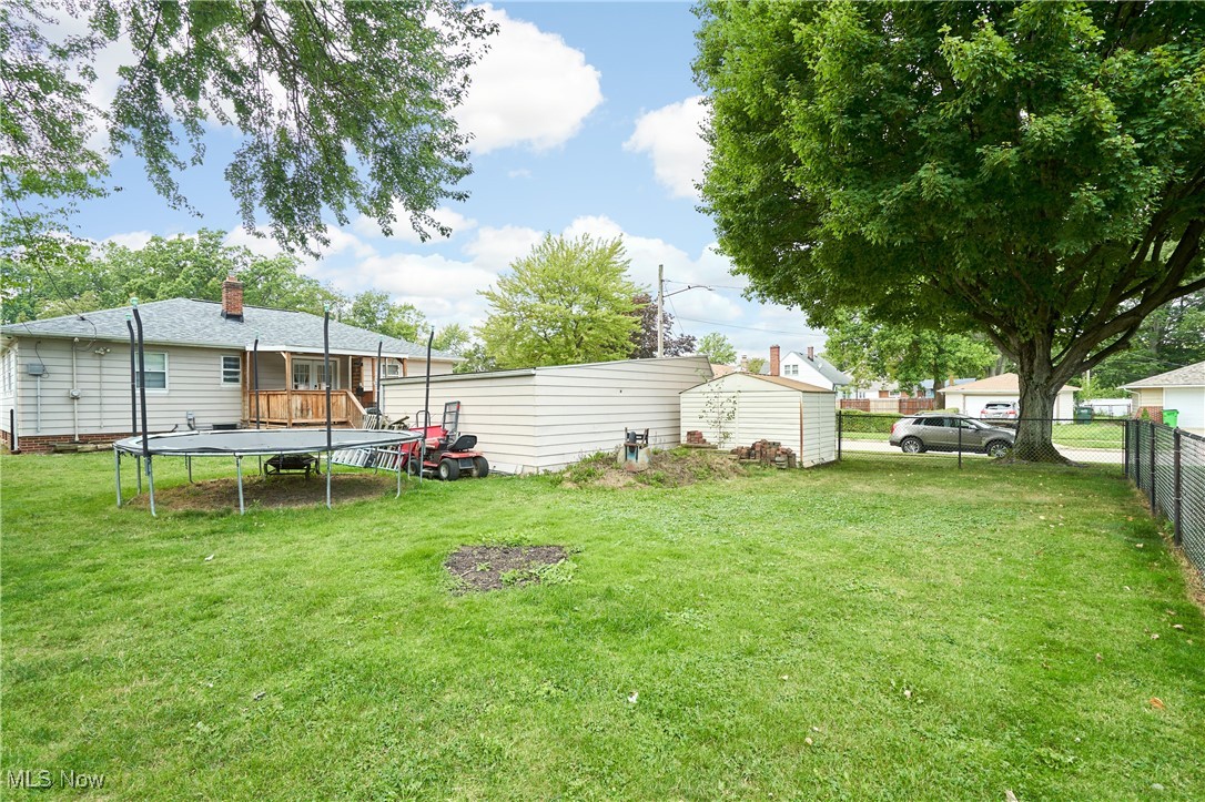 1129 Homestead Road Cleveland, OH 44121 - Photo 6 of 26 View of yard with a trampoline and a deck