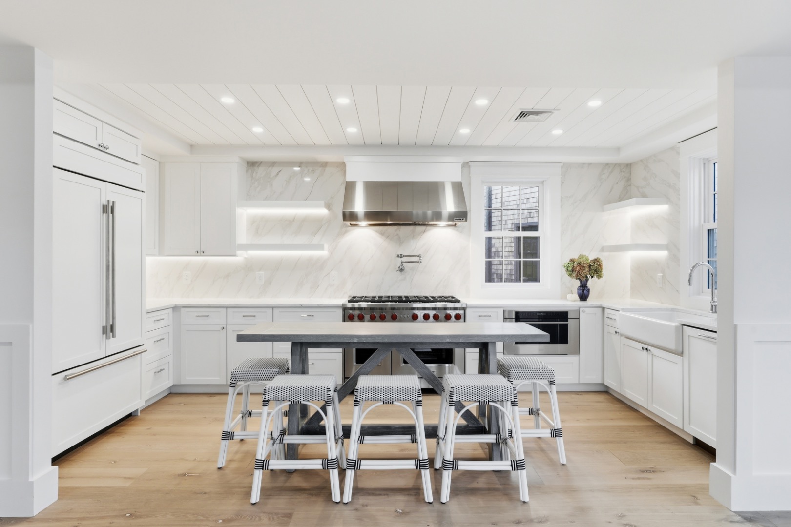 6 Mariner Way Nantucket, MA 02554 - Photo 7 of 31 a kitchen with a dining table chairs and cabinets
