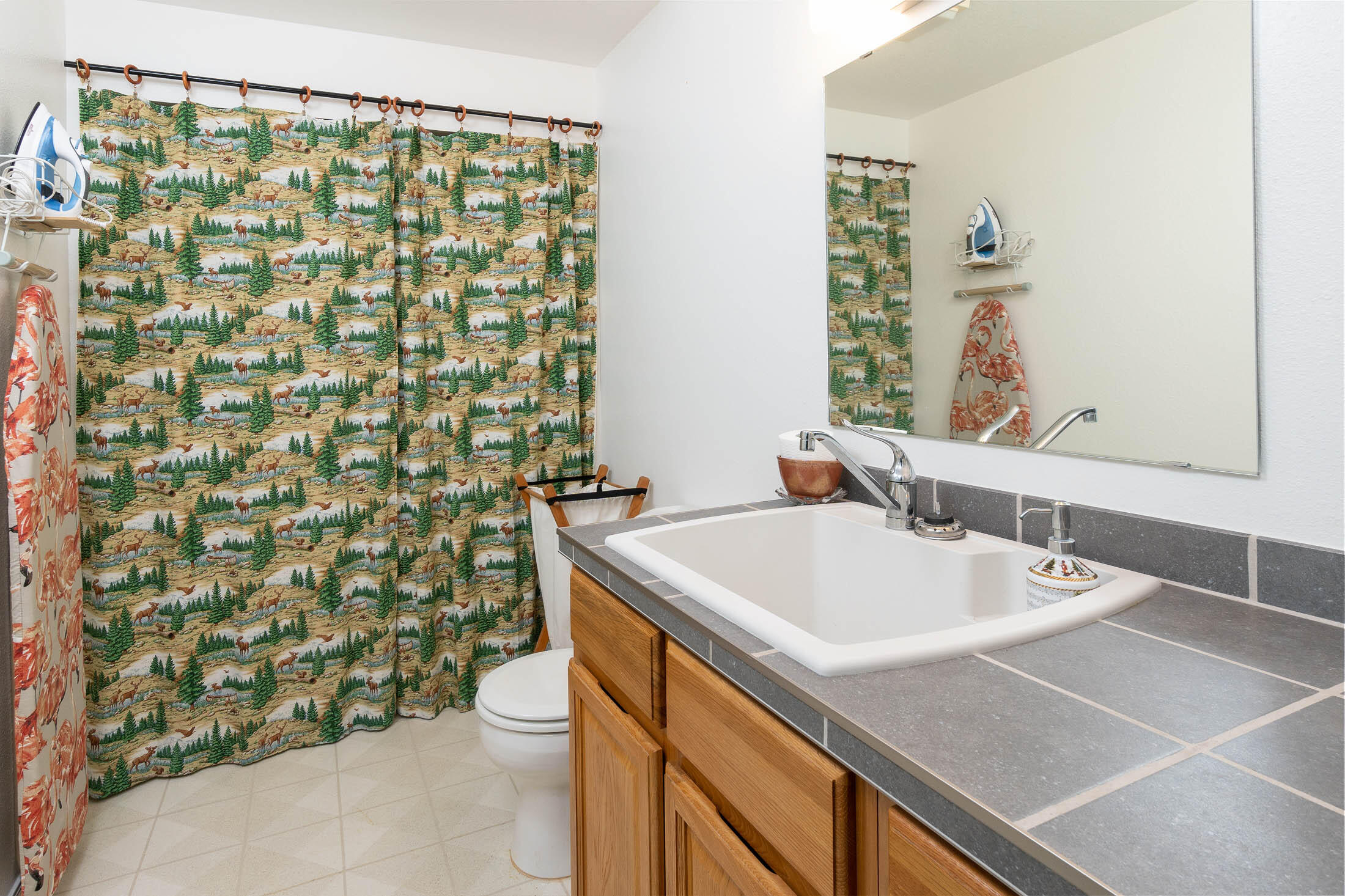 20420 Mainline Road Bend, OR 97702 - Photo 12 of 29 a bathroom with a sink a toilet and shower curtain
