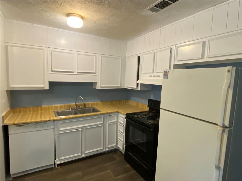 3062 Ferrite Loop Northwest Lawrenceville, GA 30044 - Photo 2 of 10 a kitchen with stainless steel appliances granite countertop white refrigerator stove a sink and dishwasher