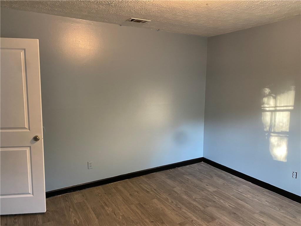 3062 Ferrite Loop Northwest Lawrenceville, GA 30044 - Photo 4 of 10 an empty room with wooden floor and windows