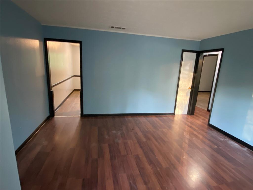 3062 Ferrite Loop Northwest Lawrenceville, GA 30044 - Photo 9 of 10 an empty room with wooden floor and a window