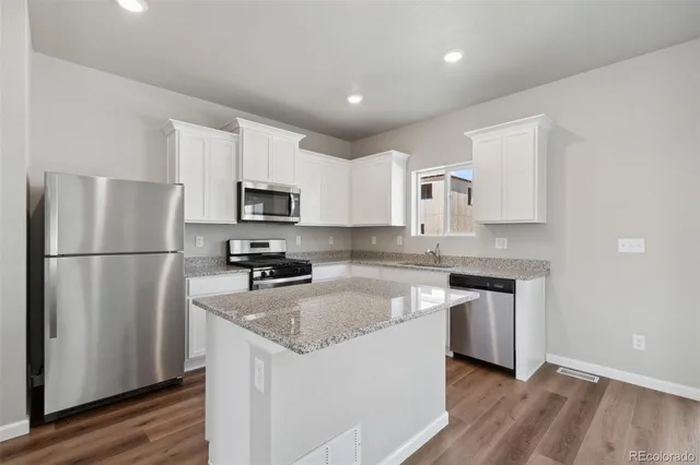 a kitchen with a refrigerator sink and microwave