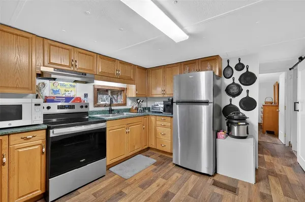 a kitchen with stainless steel appliances granite countertop a sink and cabinets