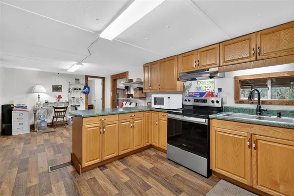 a kitchen with sink and refrigerator