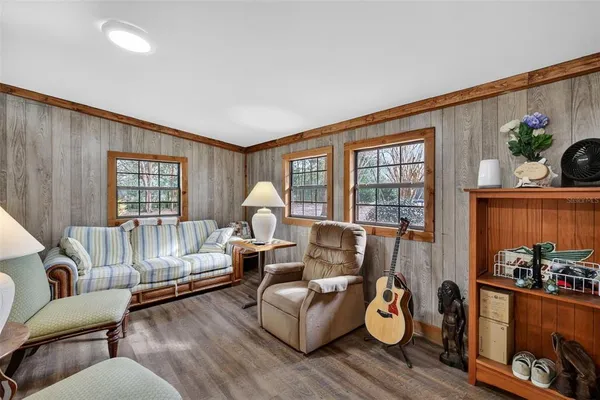 a bed sitting in a spacious bedroom next to a window