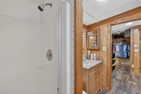 a bedroom with bed and wooden floor