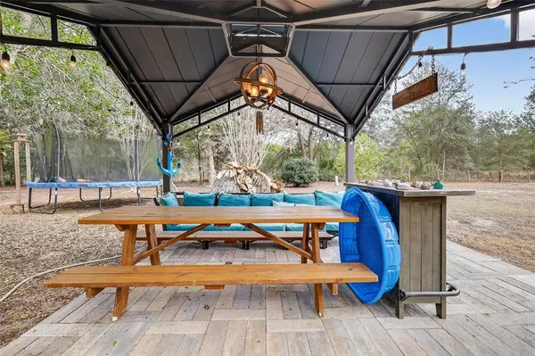 a view of dirt yard with a trees