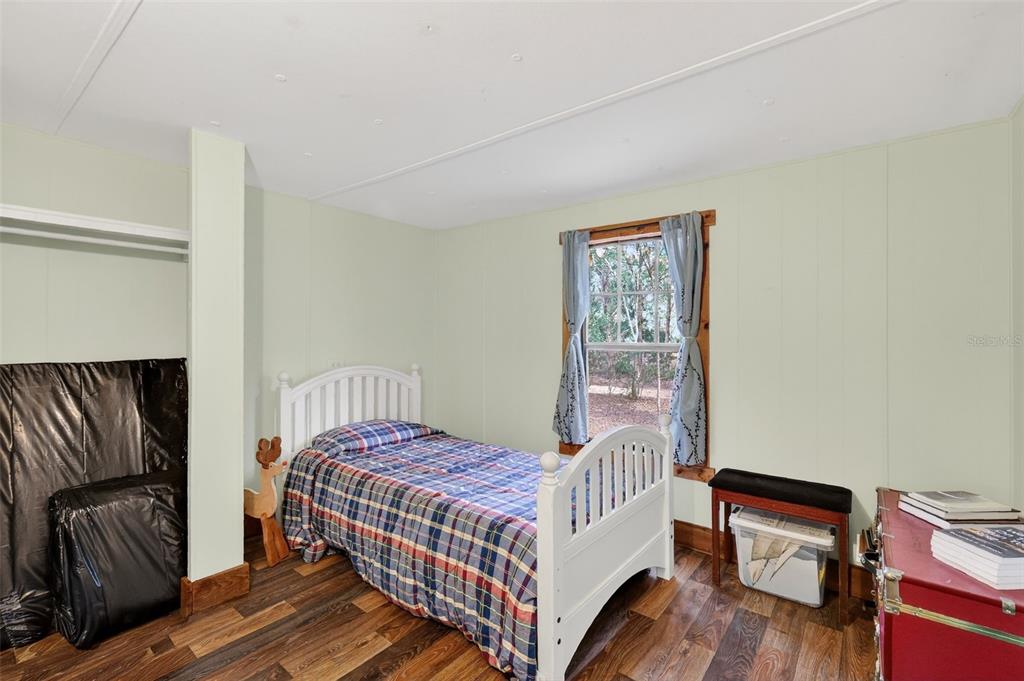 40635 Thomas Boat Landing Road Umatilla, FL 32784 - Photo 33 of 44 a bedroom with a bed and wooden floor