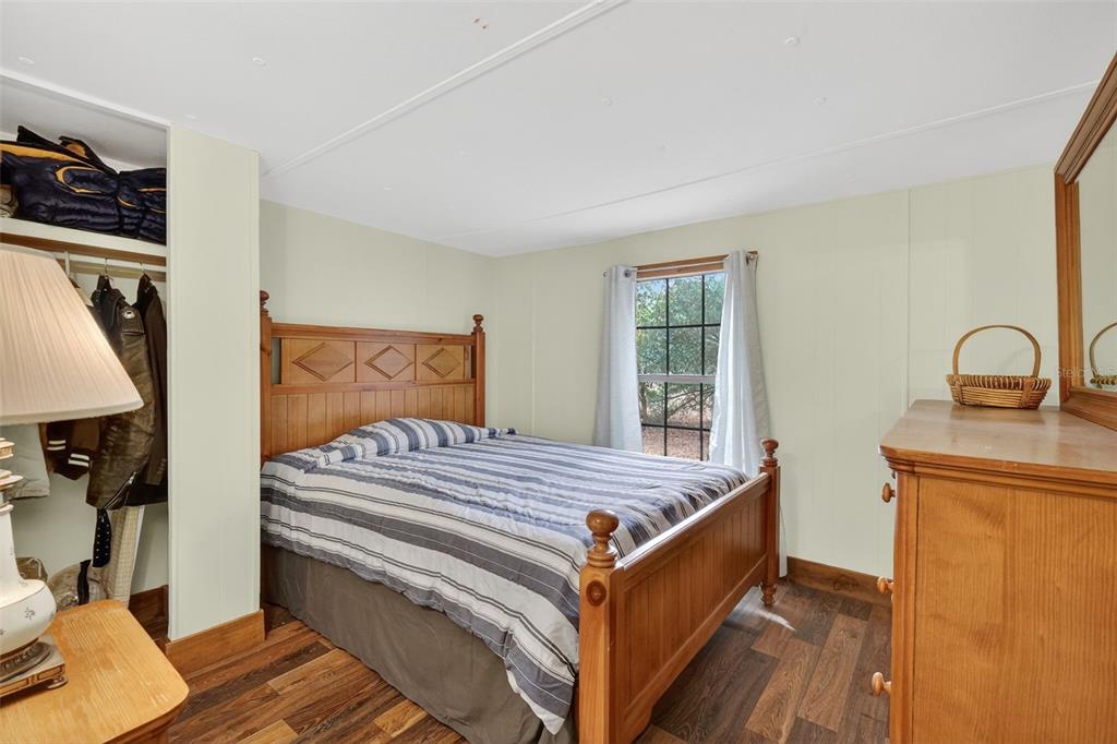 40635 Thomas Boat Landing Road Umatilla, FL 32784 - Photo 36 of 44 a bedroom with bed and wooden floor