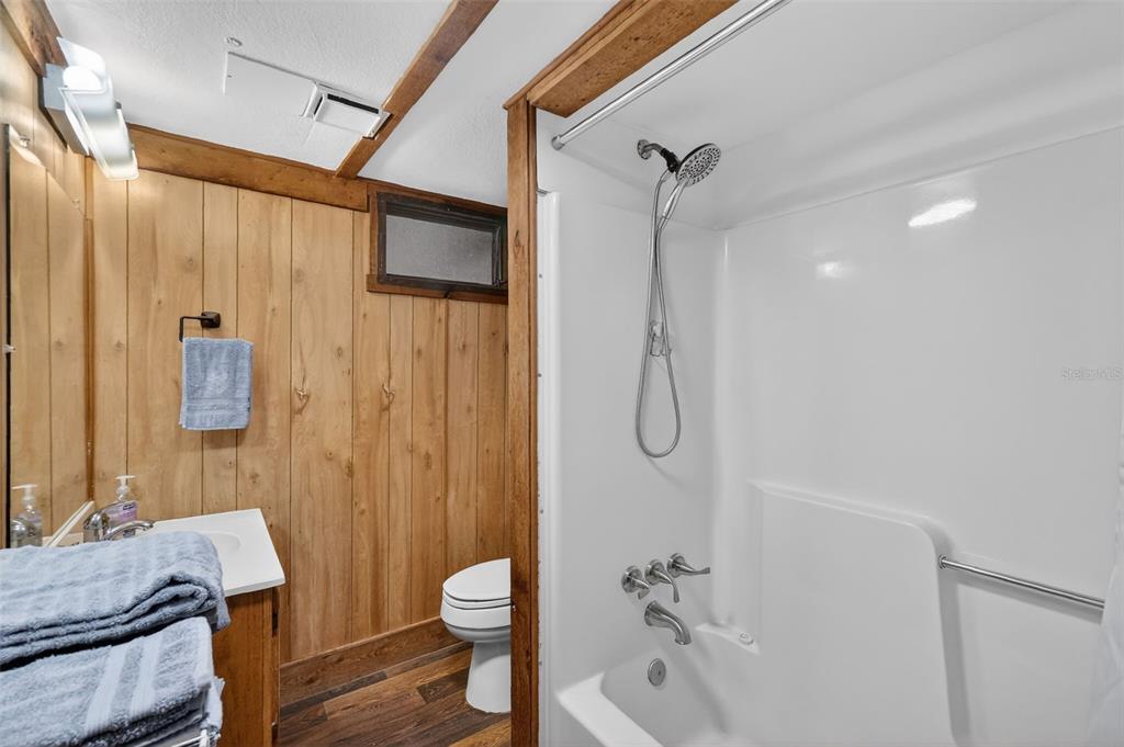 40635 Thomas Boat Landing Road Umatilla, FL 32784 - Photo 37 of 44 a bathroom with a granite countertop sink toilet and shower