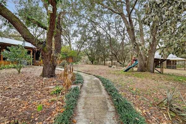 a pathway of a house with a yard