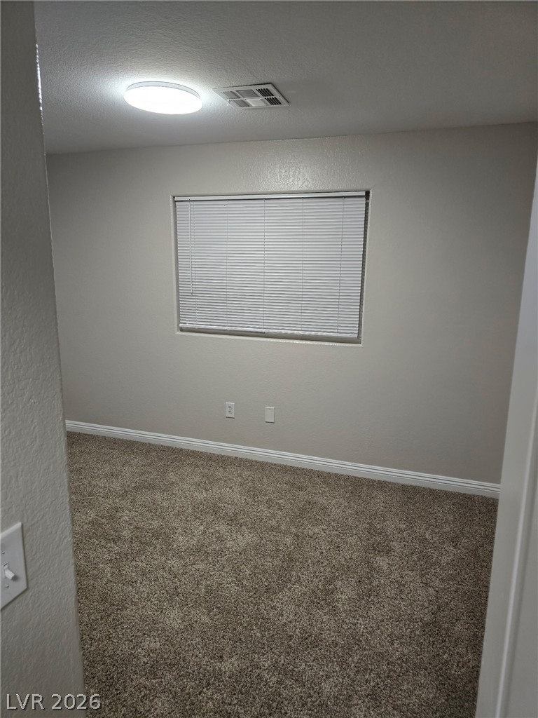 4730 East Craig Road, Unit 2142 Las Vegas, NV 89115 - Photo 5 of 8 This cozy bedroom features plush carpeting, offering comfort and warmth to the space.