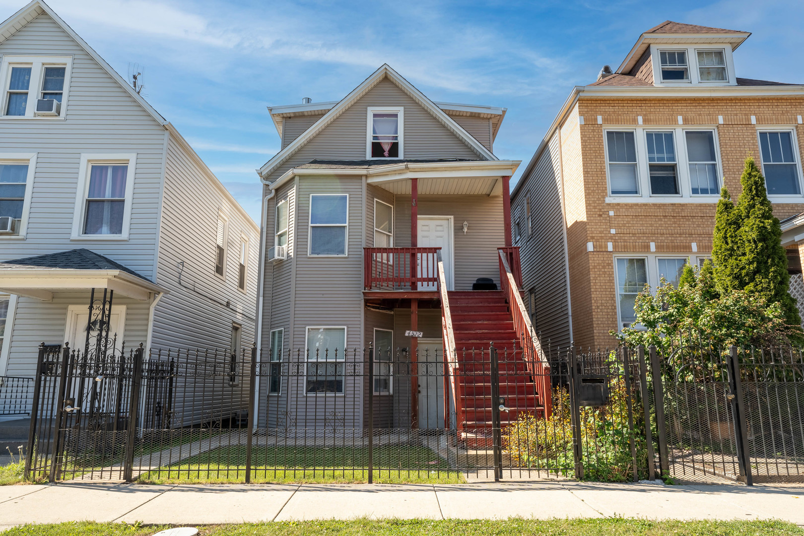 4512 South Fairfield Avenue, Unit 3 Chicago, IL 60632 - Photo 1 of 5 a front view of a house with glass windows and door