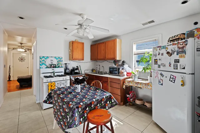a kitchen with stainless steel appliances granite countertop a refrigerator stove and sink