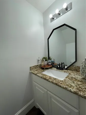a bathroom with a sink a toilet and shower curtain