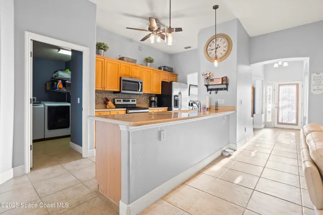 a very nice looking kitchen with a dining table and chairs