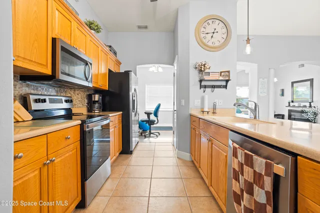 a large kitchen with stainless steel appliances granite countertop lots of counter top space