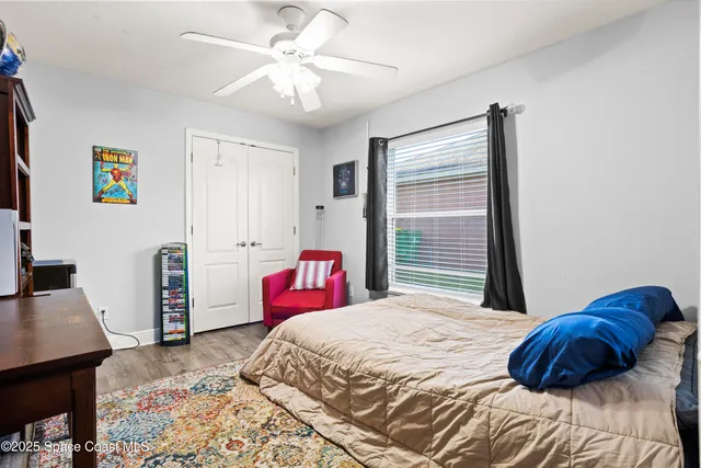 a bedroom with a bed dresser and a window