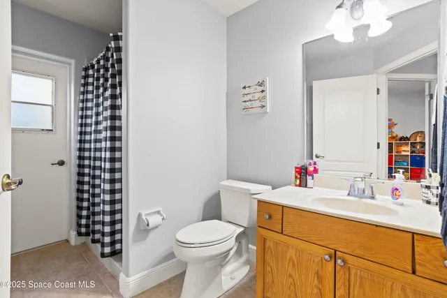 a bathroom with a sink vanity mirror and toilet