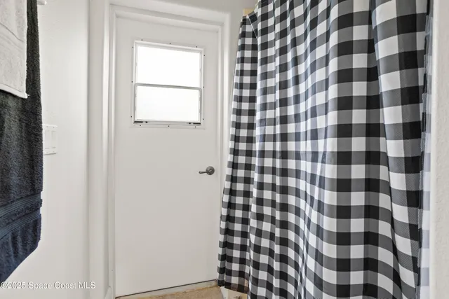 a bathroom with a black and white checkered floor