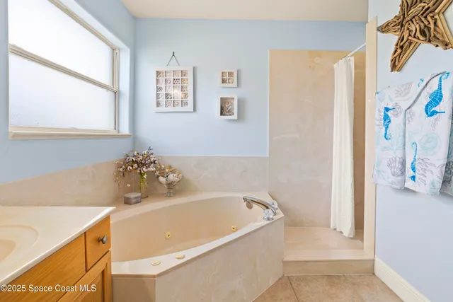a bathroom with a bathtub and a window