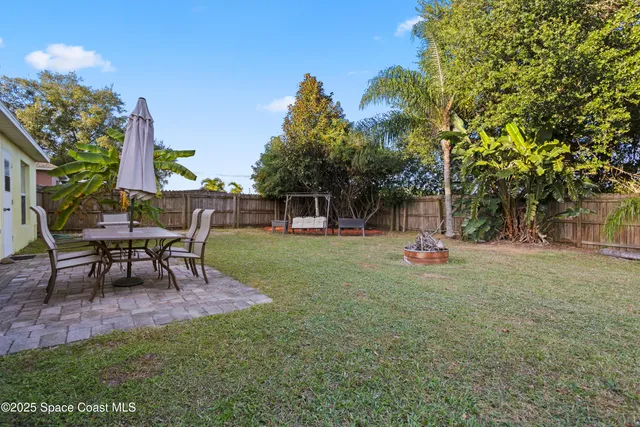 a view of a house with a yard and sitting area