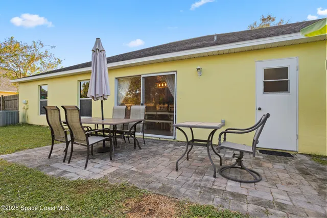 a view of a patio with table and chairs