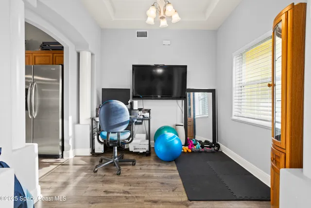 a view of a livingroom with furniture and a large window