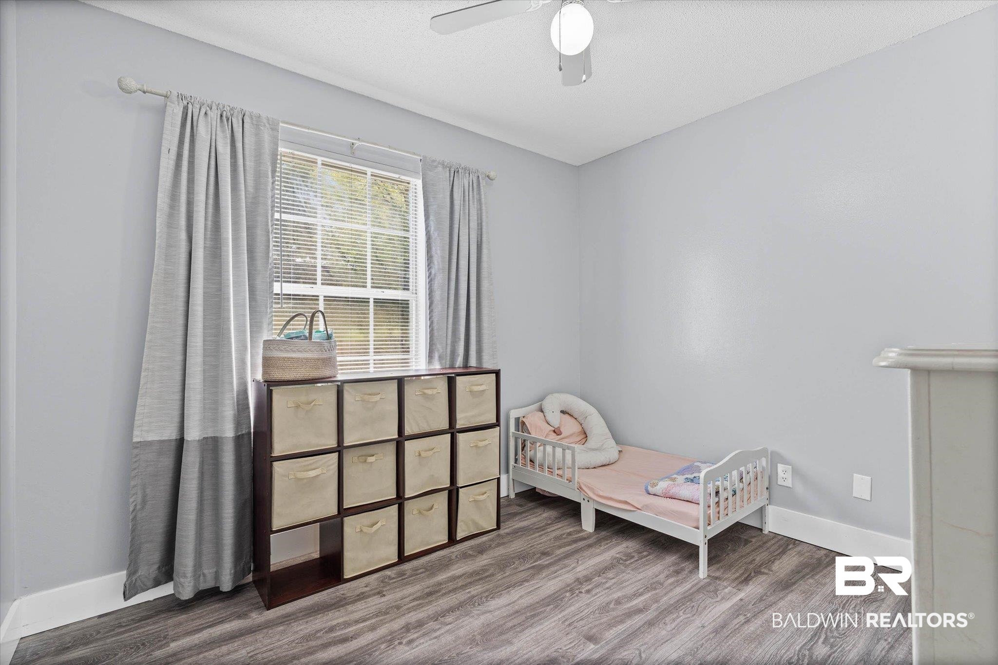 1849 Ranch House Drive Semmes, AL 36575 - Photo 15 of 23 Bedroom featuring dark wood-style floors, ceiling fan, and a textured ceiling
