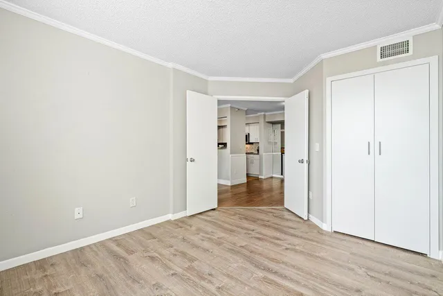 a view of empty room with wooden floor