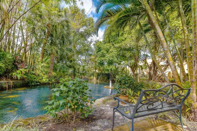 a backyard of a house with lots of green space and lake view