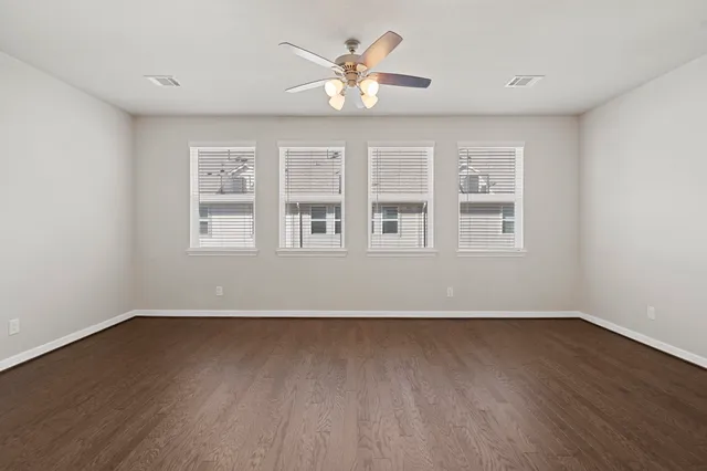 a view of an empty room with a kitchen