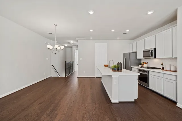 a view of a kitchen with sink and wooden floor