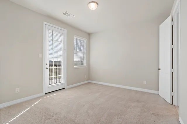 an empty room with closet and a bathroom