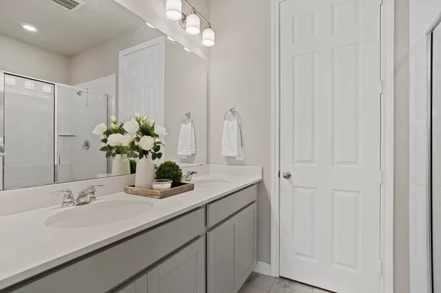 a bathroom with cabinets and mirror