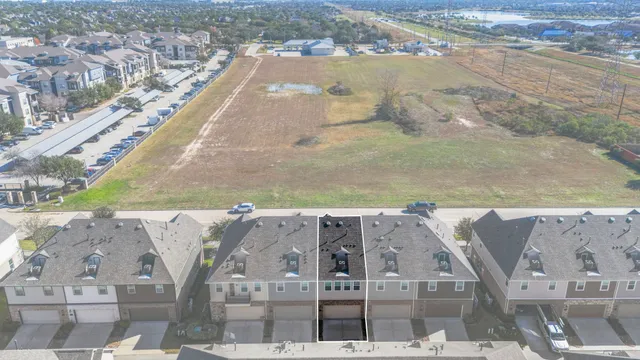 an aerial view of a house with a swimming pool and outdoor seating