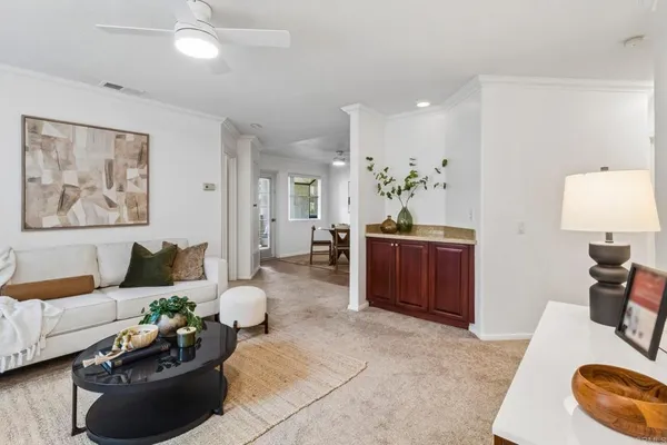a living room with furniture and a dining table