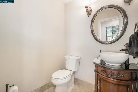 a bathroom with a toilet a sink and a mirror