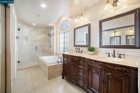a spacious bathroom with a double vanity sink mirror double and bathtub