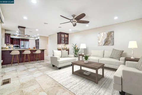 a living room with furniture and kitchen view