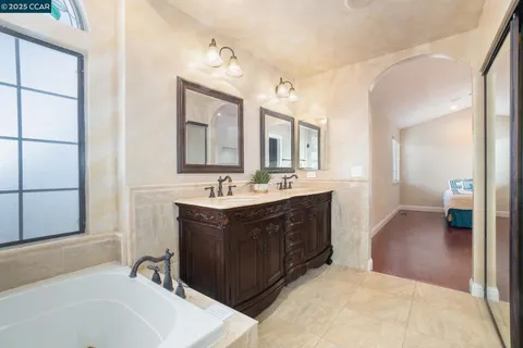 a bathroom with a sink vanity tub and shower