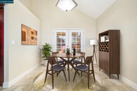 a view of a dining room with furniture and window