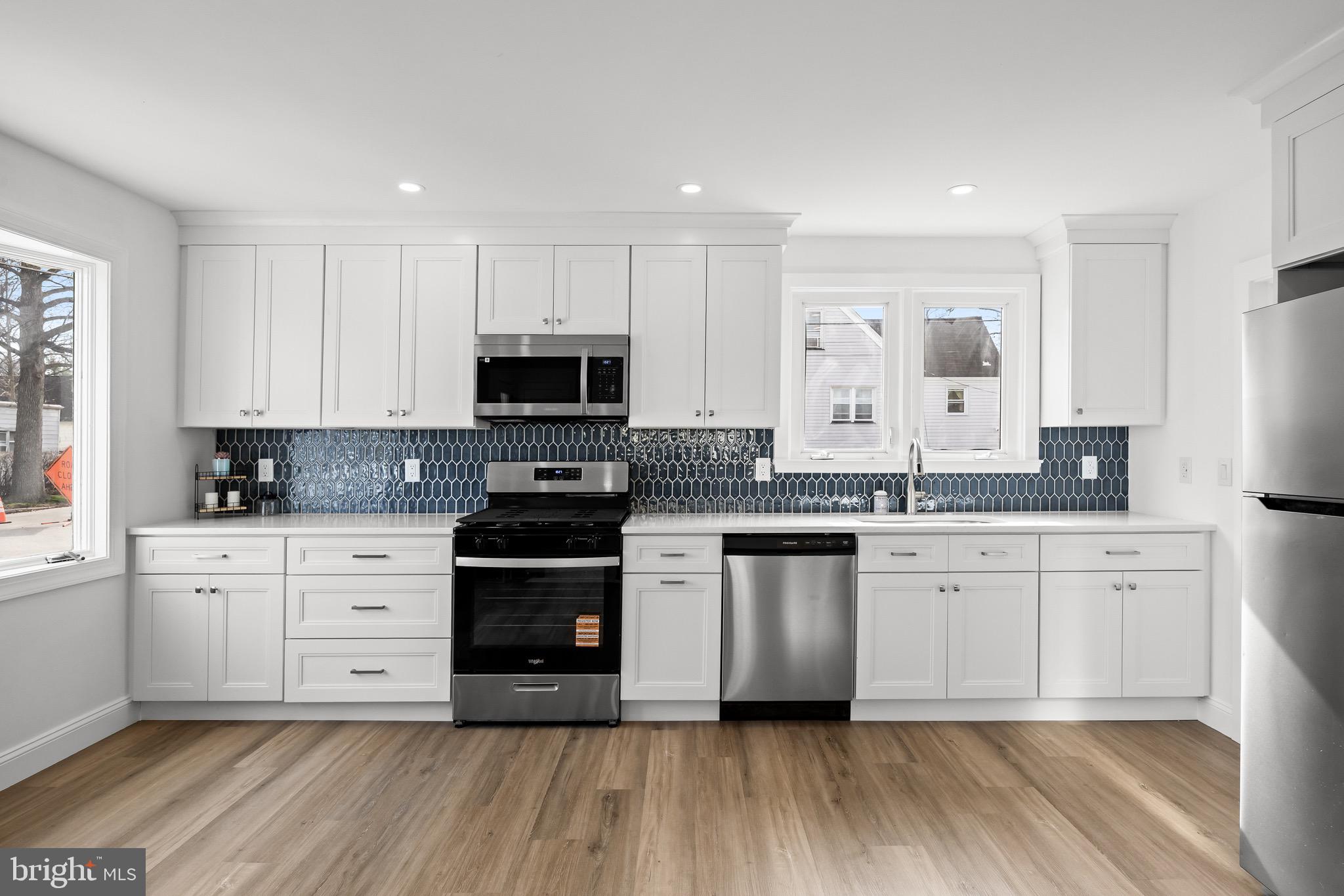 42 Spruce Avenue Maple Shade, NJ 08052 - Photo 11 of 27 a kitchen with stainless steel appliances granite countertop a stove a sink and white cabinets