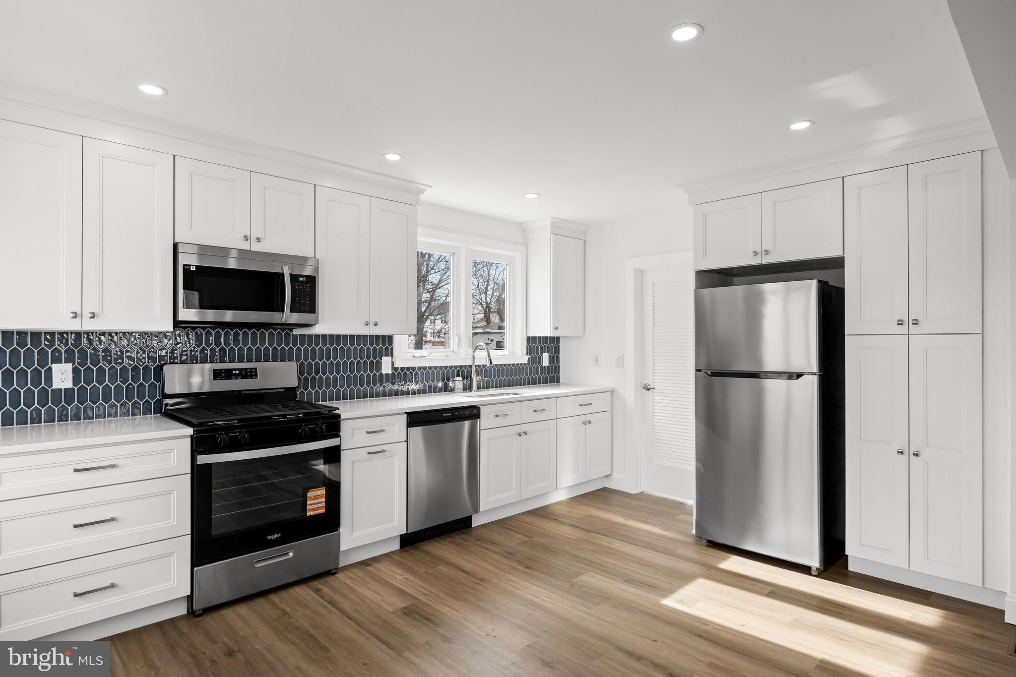 42 Spruce Avenue Maple Shade, NJ 08052 - Photo 12 of 27 a kitchen with a refrigerator stove and microwave