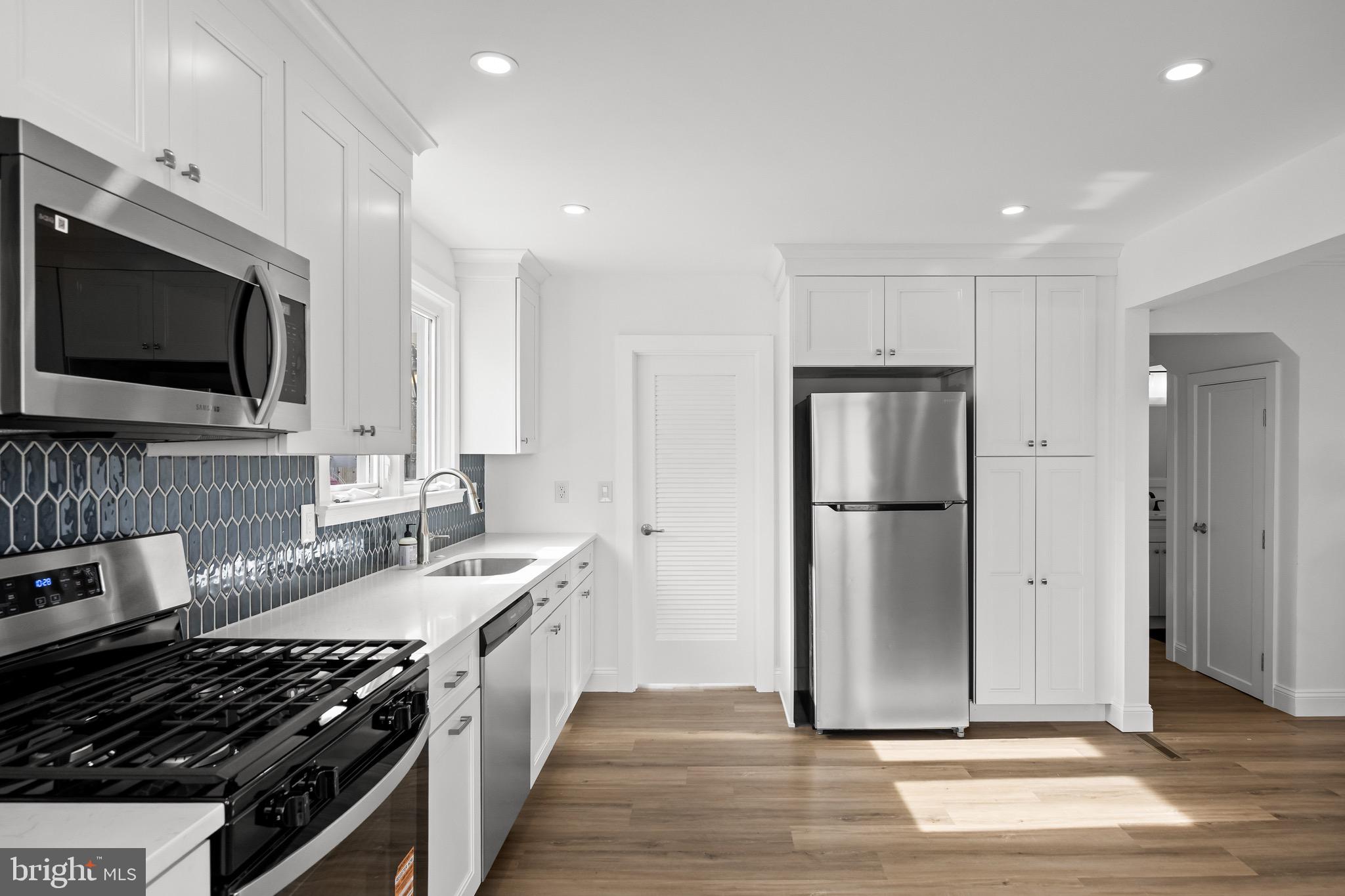 42 Spruce Avenue Maple Shade, NJ 08052 - Photo 13 of 27 a large kitchen with stainless steel appliances granite countertop a stove and a refrigerator